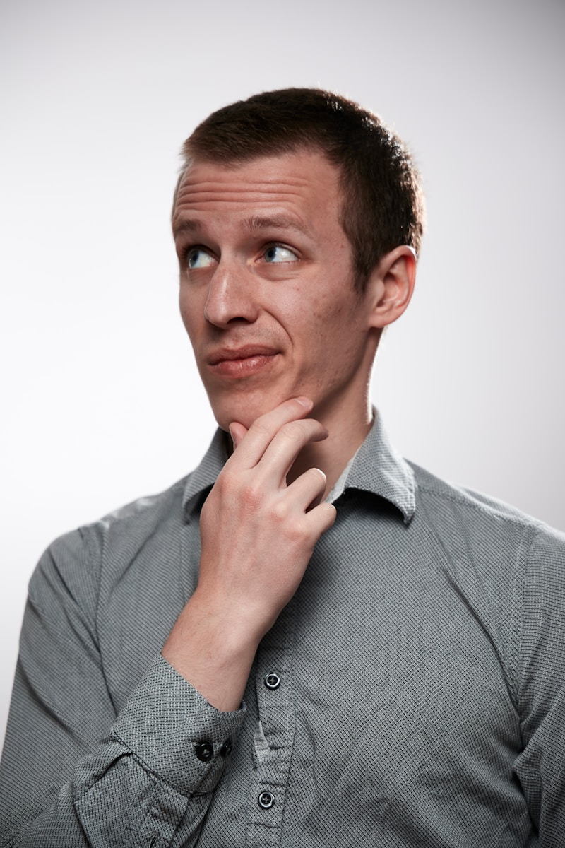 man in gray button up shirt asking why his auto insurance rates went up